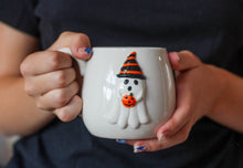 Load image into Gallery viewer, Ghost Holding Pumpkin Embossed Stoneware Ceramic Mug