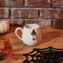 Load image into Gallery viewer, Ghost Holding Pumpkin Embossed Stoneware Ceramic Mug
