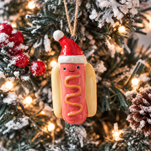 Load image into Gallery viewer, Ceramic Festive Hotdog With Santa Hat Ornament
