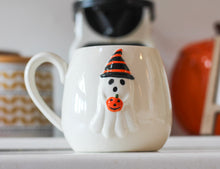 Load image into Gallery viewer, Ghost Holding Pumpkin Embossed Stoneware Ceramic Mug
