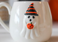 Load image into Gallery viewer, Ghost Holding Pumpkin Embossed Stoneware Ceramic Mug
